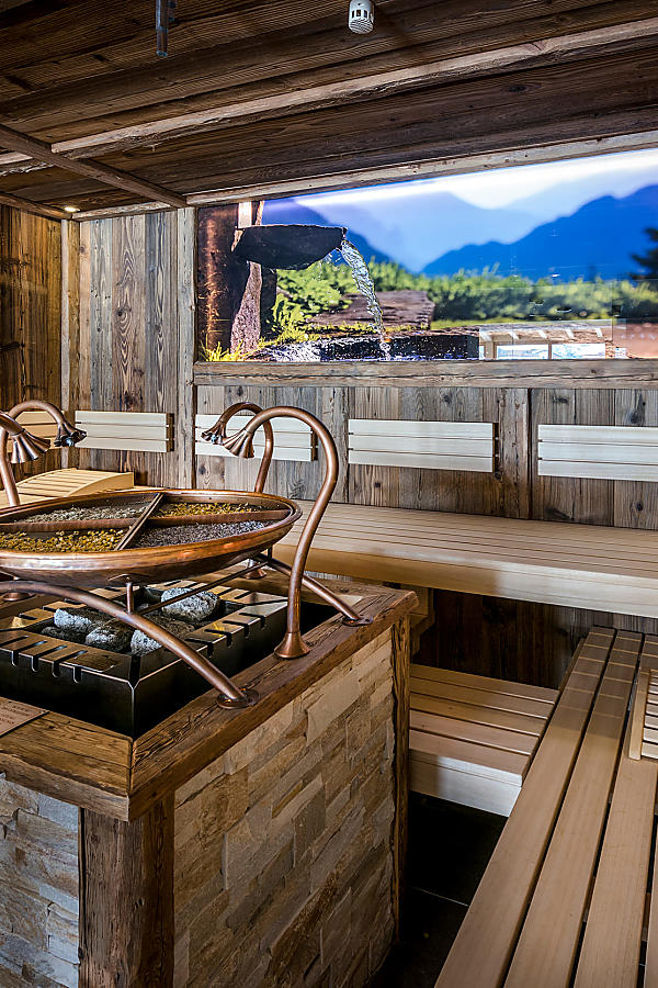Alpine herbal sauna at almlust with wooden walls and aromatic herbal infusion