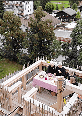 Group having breakfast on the Almlustrock climbing tower platform in Flachau