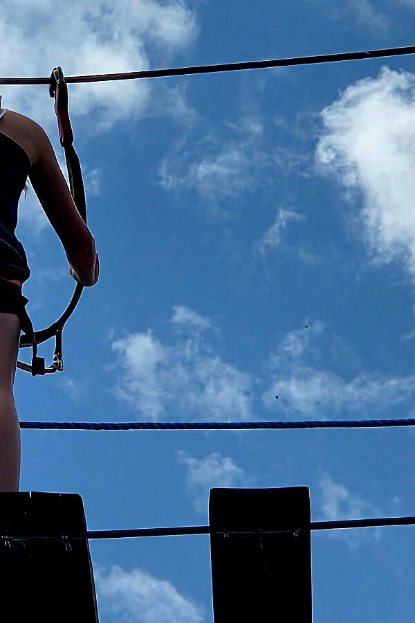 Kids on the ropes – high adventure at almlust Child on a rope bridge at the high ropes course in Flachau, seen from below against a blue sky