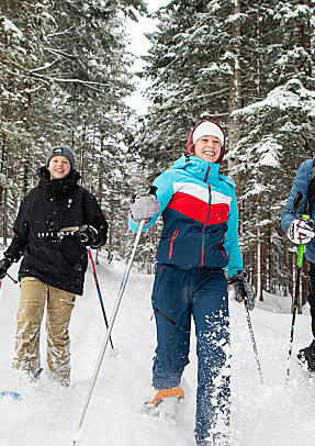 Snowshoe hikers in Flachau's forests
