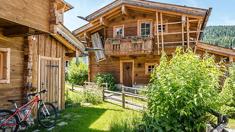 Holzchalet der almlust in Flachau mit Balkon, Garten und abgestellten Fahrrädern